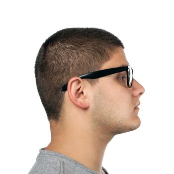 A young teenage man isolated over white wearing black frame nerd type vintage glasses.