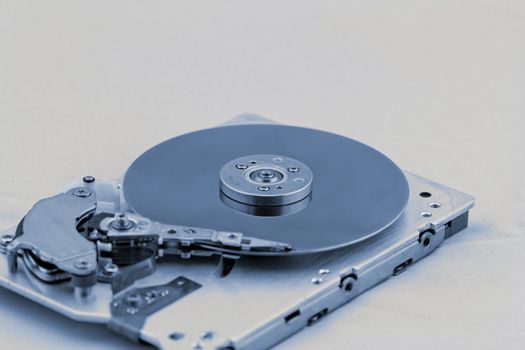 Open computer hard drive on white background with blue (HDD, Winchester)