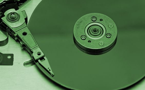 Open computer hard drive on white background with green (HDD, Winchester)