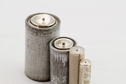 Old grey batteries on white background (aa, aaa, b, c)