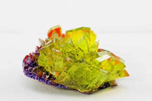 Close up picture about a crystal with topaz color on white background (yellow crystal)