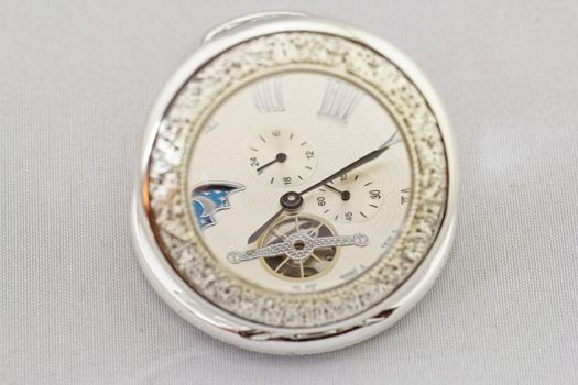 Part of a antique mechanical pocket watch on white background