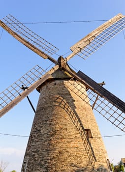 Old wooden windmill against the blue sky