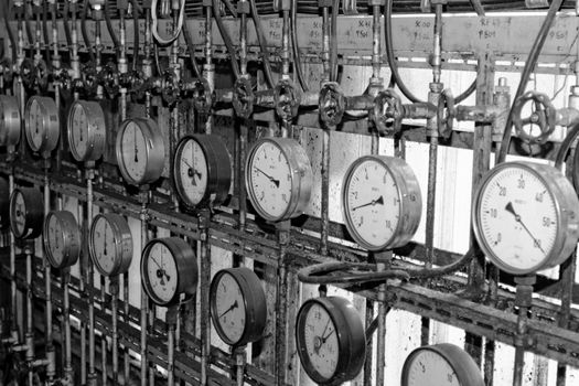 industrial steam pipes in a electricity power plant with pressure meter bw