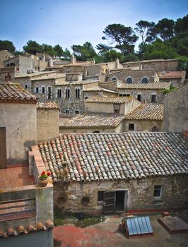 Tiles roofs of ancient spanish houses built in tiers on the side of a hill