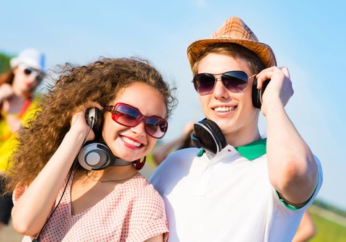 young couple standing on the road, having fun with friends