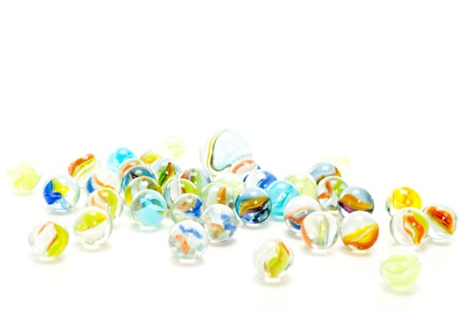 Playing with lot of colorful marbles in the spare time