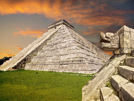 Mayan pyramid at Chichen Itza with stone snake in the foreground. Yucatan,Mexico