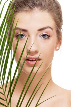 beautiful woman with blue eyes portrait isolated on white green leaves