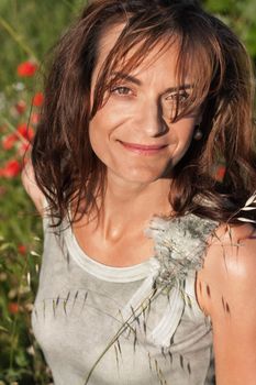 attractive smiling adult woman outside in summer portrait