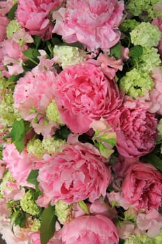 Big pink peonies in a wedding flower arrangement