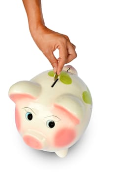 Piggy bank and hand with coin isolated on white background