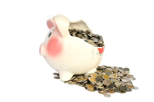 Pink piggy bank broken with money isolated on white background