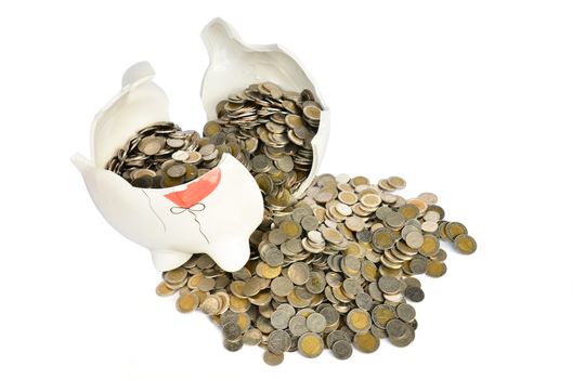Pink piggy bank broken with money isolated on white background