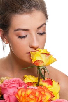 attractive young smiling woman with flowers roses isolated on white