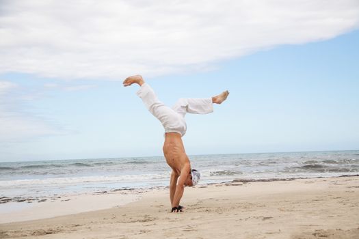 man is jumping sport karate martial arts fight kick jump beach summertime
