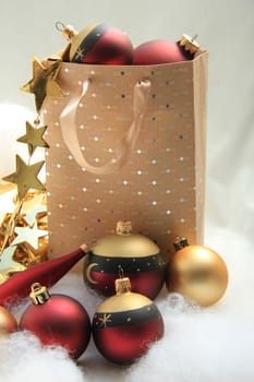 Red and golden christmas ornaments in a giftbag