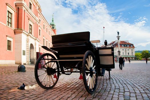 Krakowskie Przedmiescie, the old town of Warsaw, Poland. Horse hackney carriage on cobblestone