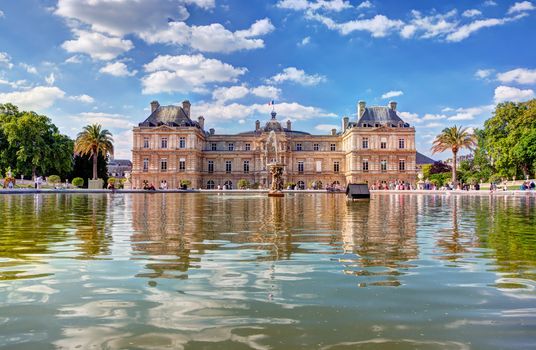 The Luxembourg Palace in The Jardin du Luxembourg or Luxembourg Gardens in Paris, France. View on the main facade and water pond