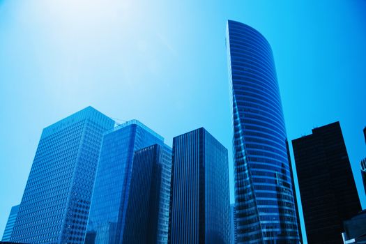 Business skyscrapers, sunny blue sky. La Defense financial district in Paris, France.
