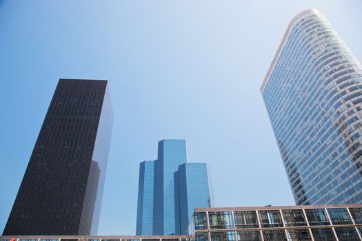 Business skyscrapers, sunny blue sky. La Defense financial district in Paris, France.