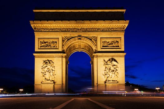 Arc de Triomphe, Paris, France at night. View from Avenue des Champs-Elysees