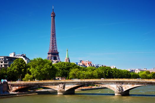 Eiffel Tower and bridge on Seine river in Paris, France. View from Alexandre Bridge at sunny day