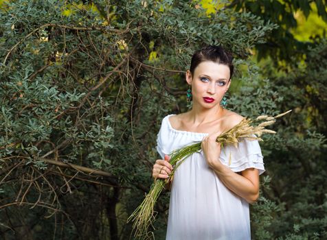 Portrait of a Girl in a White Dress with Ears of Corn