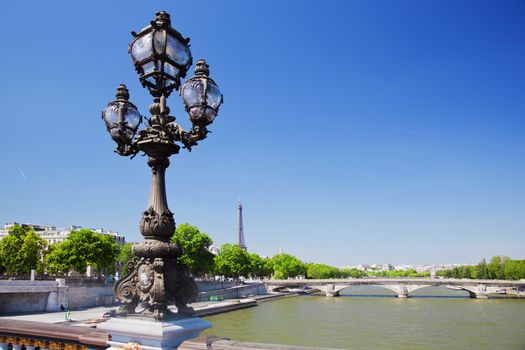 Eiffel Tower and bridge on Seine river in Paris, Fance. View from Alexandre Bridge at sunny day