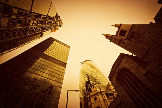 Business architecture, skyscrapers with a single old tower in London, the UK. Golden tint, conceptual