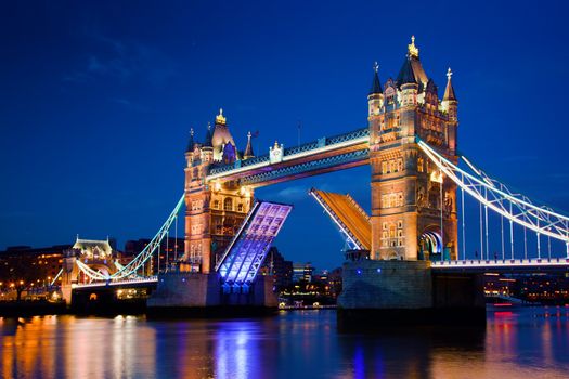Tower Bridge in London, the UK at night. The bridge is opening