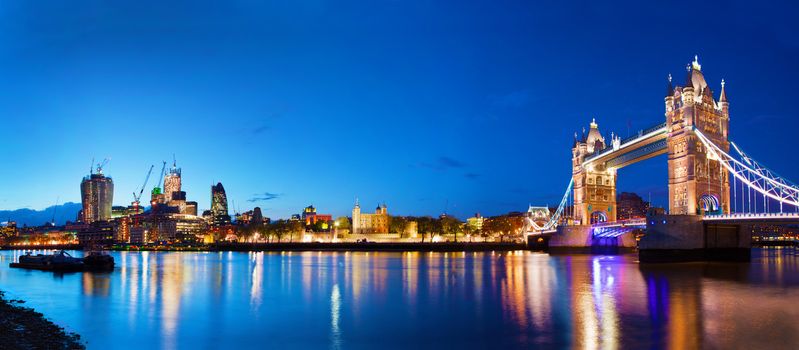 Tower Bridge in London, the UK at night. Panorama of the city centre