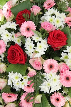 Red roses and pink gerberas in a mixed wedding centerpiece