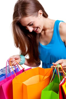 attractive young woman with colorful shopping bags isolated on white background