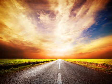 Empty asphalt road. Long and straight. Sunset Sky