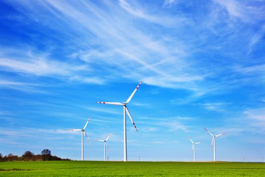 Wind turbines farm. Blue cloudy sky. Alternative eco source of energy