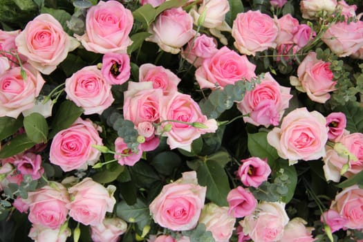 Lisianthus and roses in a pink wedding centerpiece