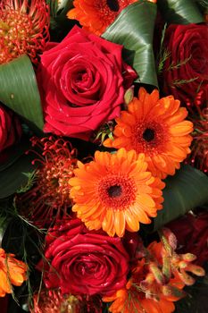 Orange gerberas and red roses in a floral arrangement