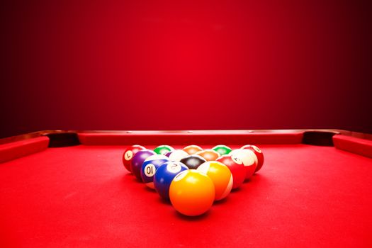 Billards pool game. Color balls in triangle. Red cloth table