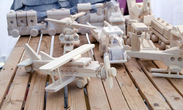 wooden handmade plane and helicopter form models toys sell in outdoor street store market fair.