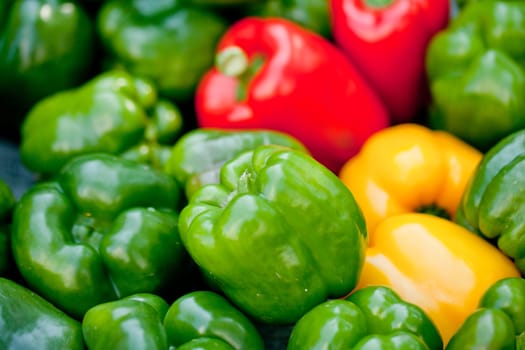 fresh healthy red yellow geen paprika pepper macro closeup market outdoor