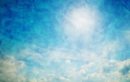 Vintage, retro image of sunny blue sky with puffy clouds. Grunge and creased canvas texture
