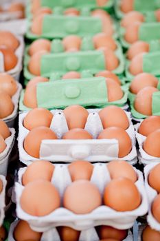 group of brown eggs in carton box closeup market outdoor