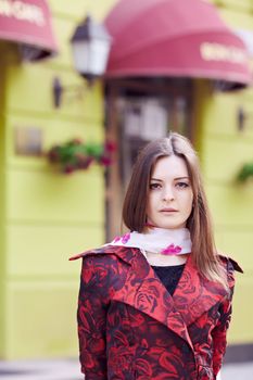 eautiful girl in a red cloak against the French restaurant