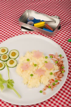 Mashed potatoes with some raw vegetables, kid meal