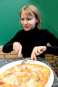 image of portrait of sympathetic young woman  in pizzeria