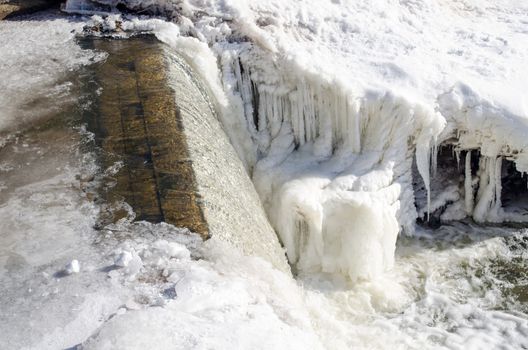 corner of river waterfall water cascade fall down. beautifully frozen ice and icicles.