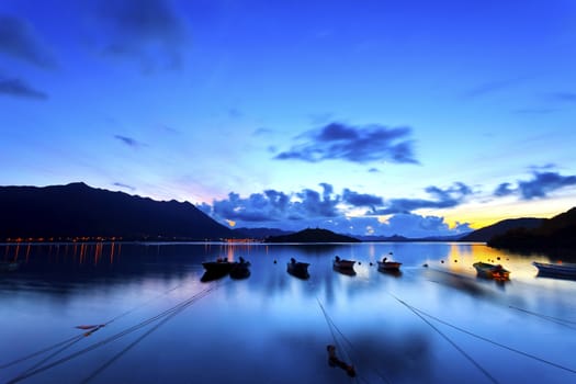 Sunrise coast with fishing boats