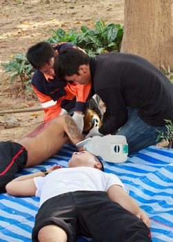 PHRAE,THAILAND - DECEMBER 20 : Unidentified  men are first aid training from staff  the hospital on  December 20, 2012 at local parks, Muang, Phrae, Thailand.