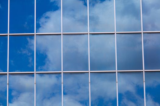 blue sky reflected in modern building mirror glass wall